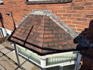Grey concrete roof tiles with dry verge caps on residential property in Leeds