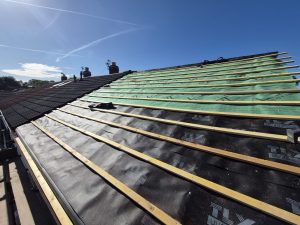 Completed roof replacement showing new concrete tiles and dry verge system in Leeds