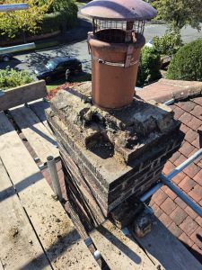 Grey concrete tile roof with dry verge caps installed on Leeds property