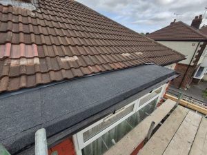 Completed chimney flaunching repair with terracotta pot and bird guard cap in Leeds