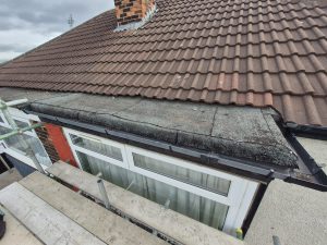 Chimney stack with fresh cement repairs and protective cap on residential property in Leeds