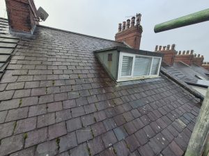 Victorian slate roof with Velux window and dormer on terraced house in Leeds