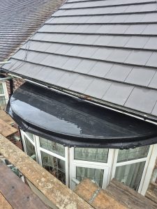 Flat roof felt repair above bay window on Victorian brick house in Leeds