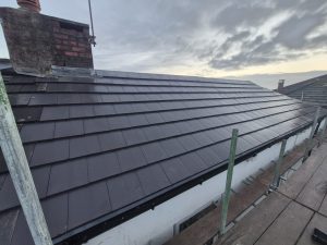 Completed slate roof replacement with new dark slate tiles and lead flashings by CL Stewart Roofing