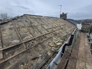 Old roof strip and removal during re-roofing project by CL Stuart Roofing