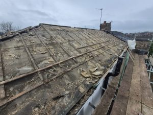 Complete roof strip down showing exposed battens and old felt removal by CL Stewart Roofing