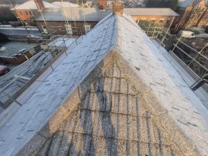 Slate roof ridge viewed from above with scaffolding erected for safe access by CL Stewart Roofing